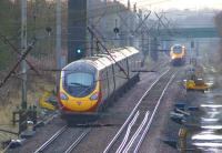 Looking south over the summit on the WCML between Coppull and Standish on 23 November 2012. A Pendolino runs towards its next stop at Wigan as a northbound Voyager heads for Preston.<br><br>[John McIntyre 23/11/2012]