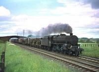 Black 5 no 45142 with an up freight near Plumpton, north of Penrith, in the 1960s. [See image 23599 for the view north from the bridge].  <br><br>[Robin Barbour Collection (Courtesy Bruce McCartney) //]