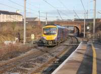 A TPE service for Glasgow Central passes through Penrith station at speed. 185119 is just passing the barrow crossing. This is for staff use only and, because of the restricted view, has a light on each side which goes out when a train is approaching (useful for enthusiasts as well as railway workers). <br><br>[Mark Bartlett 30/11/2012]