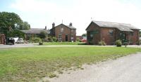 The former Masham station and goods yard in June 2011. The station, which stood at the end of a single line from Melmerby North Junction, was once served by branch trains from Ripon. Closed to passengers in 1930, Masham remained open for freight for another 33 years. On the left is the old station building and station master's house, with former railway cottages beyond. The old goods shed on the right has now been converted to a cafe and picture gallery.<br><br>[John Furnevel 27/06/2011]