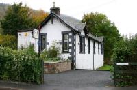 Entrance to the 1867 station at Walkerburn in October 2005. The line arrived via a level crossing off picture to the left. Note the area between the former canopy and the platform has been incorporated within an extension to the property. View is west towards Innerleithen.   <br><br>[John Furnevel 07/10/2005]