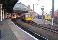 On the left is the 1537hrs to Glasgow via Edinburgh and to its right a Pacer <br>
forms the 1524hrs to Carlisle from the new island platform. The Pacer on the <br>
far right is stabled between duties, but a crossover behind the unit means <br>
this platform is still available for through trains departing to the south <br>
and west.<br>
 <br><br>[Malcolm Chattwood 01/12/2012]