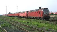 Halberstadt, on the western side of the former DDR, was a class 219 stronghold into the 21st century, albeit by the summer of 2002 class 218s from the west had made big inroads into their numbers. A long line of 219s stands in the shed yard in August 2002 in a variety of liveries - the first two in DB 'Orient red', followed by a number in the current (2012) DB 'traffic red', with an example further down the line still in DR burgundy with cream stripes [see image 41353].<br><br>[Bill Jamieson 24/08/2002]