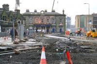 View west over what is normally one of Edinburgh's busiest road junctions, seen here on 12 December 2012, with tramworks having taken over completely. Beyond the station building work is underway on expansion of the existing facilities to cope with future train/tram/bus/taxi interchange traffic.<br><br>[John Furnevel 12/12/2012]