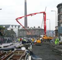 Looking west along Shandwick Place towards Haymarket station on 12 December with tramworks in full swing. In the background, work is also underway on Haymarket station and interchange, with the jib of the 1,000 tonne capacity crane now on site protruding well above the station roof. [See news item]<br><br>[John Furnevel 12/12/2012]