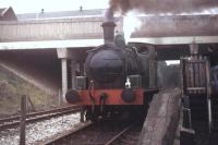 When the East Lancashire Railway was first established in Bury operations were confined to a short demonstration line from the Transport Museum in the old Castlecroft Goods shed yard. This was later realigned and extended alongside the Rawtenstall freight line just to the north of Bolton St tunnel. Former Manchester Ship Canal Hunslet 0-6-0T No. 32 <I>Gothenburg</I> is seen around 1979 in steam at the temporary platform used for brakevan trips at that time.<br><br>[Mark Bartlett //1979]