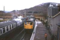 The traditional mid-day crossing scene at Achnasheen on a dull day in the 1970s.<br><br>[Frank Spaven Collection (Courtesy David Spaven) //]