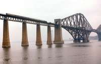 Two pre-1955 Modernisation Plan liveried coaches stand out on a northbound train crossing the Forth Bridge on 16th July 1961. The north tower of the emerging road bridge can be glimpsed in the background.<br>
<br><br>[Frank Spaven Collection (Courtesy David Spaven) 16/07/1961]