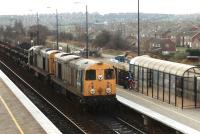 A pair of the once prolific class 20's, nos 20092+20185, working north through the 1990 Swinton Station with a rake of empty engineers short wheelbase open wagons in March 1992. The fate of the two locos varied greatly, in that the trailing loco, 20185, only remained in service a further two months, being cut up at MC Metals in Glasgow in Feb '94, As of March 2016 the lead loco 20092 is indicated as still extant, albeit in store at Long Marston.<br><br>[David Pesterfield 16/03/1992]