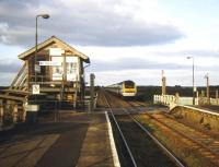 <I>'Your continued support is much appreciated...'</I> The heavily buttressed signal box at Shippea Hill, between Ely and Norwich, about to be passed by a westbound HST in the summer of 1997. Shippea Hill stands in a totally flat Fen landscape a considerable distance from any substantial settlement and sees very low passenger numbers. There is nothing remotely resembling a hill anywhere near here. <br><br>[Ian Dinmore 23/06/1997]