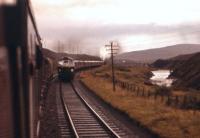 A short-lived traction combination on the Highland Main Line. A single Birmingham Type 2 heading an Inverness bound train battles up the gradient south of Dalnaspidal in September 1961, with a 2-6-4 tank banking in the rear.<br><br>[Frank Spaven Collection (Courtesy David Spaven) 06/09/1961]