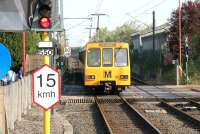 A Tyne & Wear Metro service leaves Callerton Parkway station via the level crossing on 10 May 2006. The train has just over half a mile to run to the terminus at Newcastle Airport.<br><br>[John Furnevel 10/05/2006]