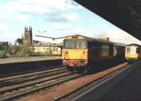 BR Class 58 no 58026 powers through the centre road at Leamington Spa station on an ex Didcot Power Station empty MGR working. The train is passing a pair of Derby lightweight DMUs standing at through platform 2 and bay platform 4.<br><br>[David Pesterfield 21/05/1986]