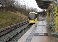 Dean Lane closed to rail services with the <I>Oldham Loop</I> in 2009. It reopened in 2012 as Newton Heath & Moston for Metrolink tram services. At this point trams are confined to a single line as the other line seen here is for container trains to and from the waste transfer facility just beyond the bridge. The old railway station platforms have been removed. Tram 3023 leaves for Oldham and Shaw, the then limit of operations until the Rochdale line reopened in 2013.<br><br>[Mark Bartlett 28/12/2012]