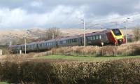 A northbound Voyager catches the sun as it passes through southern Cumbria, close to the former station at Burton and Holme, on 18 February 2012. [See image 22857]<br><br>[John McIntyre 18/02/2012]