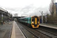 With electrification from Manchester to Newton-le-Willows scheduled to be completed by the end of 2013, masts are starting to appear all along the eastern half of the L&MR. On a gloomy afternoon in December 2012, Arriva Trains Wales 158835 passes a new mast at Eccles station as it hurries through on a train from North Wales to Manchester. Over on the Liverpool platform holes are being excavated for further installations.<br><br>[Mark Bartlett 28/12/2012]