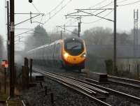 An 11 car Pendolino rushing northwards at Brock on a dark a miserable 4 January 2013. It is about to cross the River Brock and pass the site of the former station which closed in 1939.<br><br>[John McIntyre 04/01/2013]