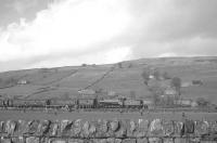 Looking across fields towards K4 2-6-0 no 3442 <I>The Great Marquess</I>, between Eastgate and Westgate-in-Weardale on the Wearhead branch. The train is the RCTS <I>'North Eastern No 2 Rail Tour'</I> of 10 April 1965 during a photostop on the return from St John's Chapel.<br><br>[K A Gray 10/04/1965]