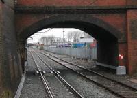 The south side of Newton Heath MPD, as seen from the platform of Newton Heath & Moston Metrolink stop, formerly Dean Lane station. The sidings now occupied by Northern Sprinters once accommodated main line diesel locomotives [See image 29691]. This view looks towards Thorpes Bridge Junction and shows the freight line to Dean Lane waste transfer station with the original bullhead rail, and the new Metrolink electrified tram line becoming double track just beyond the bridge. <br><br>[Mark Bartlett 28/12/2012]