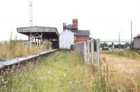 Scene at Woodhall Junction, Lincolnshire, looking north in 1977, some seven years after closure to passengers. The through Boston - Lincoln platforms are over to the left, the Horncastle bay platform (into which branch trains reversed) lies straight ahead and the former goods yard is on the right. <br><br>[Ian Dinmore //1977]