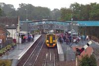 One of tennis player Andy Murray's lesser known achievements (even to him) is the record for the maximum number of fans it is possible to cram into a 158 unit on a wet Sunday morning. Arriving behind time in Dunblane because of the extra patronage for Murray's celebratory walkabout in the town on September 16th 2012, 158 869 takes several minutes to release a multitude into a welcoming downpour.<br><br>[Mark Dufton 16/09/2012]