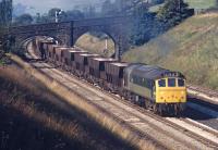 You can almost hear the crackle of the Sulzer exhaust as BR Type 2 No. 5274 toils up to Chinley station with empty ICI hoppers from Winnington (Northwich) bound for the limestone workings at Tunstead in 1971. This loco was one of the original batch sent new to Trafford Park shed (9E) in the summer of 1964 specifically for these duties.<br><br>[Bill Jamieson 21/09/1971]