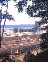An Aberdeen-Inverness DMU drifts past Millburn Yard in the early 1970s.<br><br>[David Spaven //]