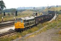 A partially fitted coal train bound (probably) for Toton Yard trundles along the up slow line at Clay Cross in 1971 with Brush Type 2 No. 5806 in charge. This was another example of the class which had the new corporate logo applied while still wearing green livery [see image 40233].<br><br>[Bill Jamieson 19/07/1971]