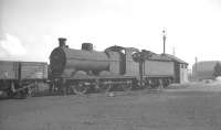 Robinson J11 0-6-0 (GCR class 9J) no 64308 on Frodingham shed, Scunthorpe, around 1960. Built in 1901/1902, the 174 locomotives of class J11 were given the nickname 'pom-poms' due to the similarity of their exhaust beat to the sound of the rapid-fire gun used by the British Army at that time. 64308 was eventually withdrawn from Frodingham in October 1961, having spent the whole of the BR period at the shed. [With thanks to Vic Smith, Alan Dixon and Jim Rafferty]<br><br>[K A Gray //1960]