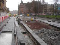 View south towards Princes Street on 10 January 2013 showing works on both track and tram stop at St Andrew Square well advanced, with the final surface being installed along most of its length. <br><br>[David Pesterfield 10/01/2013]