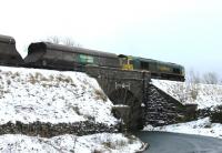 This southbound coal train has just crossed the summit at Ais Gill and is now accelerating along the undulating section through Garsdale and Dent to Blea Moor. Freightliner 66512 caught me by surprise as no coal trains are scheduled on a Sunday and I presume this must have been either an additional working or one delayed by the weather. <br><br>[Mark Bartlett 20/01/2013]