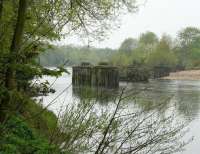 A misty morning on the Tyne a mile west of Hexham station in May 2006. The photograph is taken looking north from alongside the site of Border Counties Junction on the Newcastle - Carlisle route [see image 9290] and shows the remains of the bridge that took the Border Counties Line across the river at the start of its journey north to Riccarton Junction.<br><br>[John Furnevel 07/05/2006]