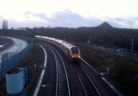 Every Sunday in January, trains from Birmingham to Derby have been diverted via the Nuneaton flyover and Leicester. This Voyager had left Birmingham at 16.12, heading for Edinburgh. The spoil heap in the right background is part of Judkins' quarry - which contributed, along with local collieries and brickworks, to a surprisingly large network of standard and narrow-gauge industrial lines around the town. Most were lifted in the 1960's, and are now hard to trace. There were also a number of tramroads in the area. Network Rail - reinstated Leicester-Birmingham flyover line<br><br>[Ken Strachan 27/01/2013]