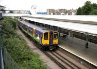 A Silverlink class 313 dual voltage emu calls at Willesden Junction Low Level station in July 2005 on a suburban service to Watford Junction. View north west from the walkway to the high level platforms.<br><br>[John Furnevel 20/07/2005]