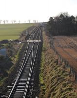 An Up ScotRail service about to enter the single line section at Usan in January 2013, having waited for a down 'East Coast' HST to clear the section. The Signal Box (cabin for a NER man?) now sadly absent (demolished some time after 2010).<br><br>[Brian Taylor 30/01/2013]