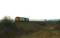 37520 has just left the Procor works at Horbury Junction in February 1997 with a rake of refurbished London Transport tube stock heading towards Wakefield Kirkgate. The signal gantry for the junction can be seen centre right.<br><br>[David Pesterfield 05/02/1997]