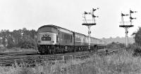 The late morning Cardiff to Newcastle express approaches Cudworth Station under caution in August 1975 behind Peak No. 46028. The lines to the right led to Stairfoot Junction, giving a connection between Wath Yard and the ex-MR main line. This has long since been expunged from the landscape, as indeed has the main line.<br><br>[Bill Jamieson 02/08/1975]