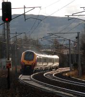 A southbound voyager passes the former junction and station at Symington in January 2013. The former route to Broughton and Peebles diverged to the left. This view is from a location to the north of the station site.<br><br>[Ewan Crawford 06/01/2013]