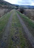 A mile east of Rachan Junction the lonely trackbed of the Caledonian Railway's extension east from Broughton to Peebles stretches off into a wild landscape. Here and there the ballast remains nearly intact.<br><br>[Ewan Crawford 06/01/2013]