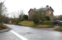 View west along the A72 from the entrance to Symington village on 6 January 2013. Opposite is Old Station House with the road into the goods yard just beyond [see image 41894]. The bridge to the left carries the WCML and on the other side is the entrance road leading up to the former station. <br><br>[John Furnevel 06/01/2013]