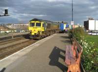 66516 brings a northbound Freightliner container train through Leamington Spa under a heavy sky on 21 March 2007. Note the ex GWR platform bench and the very tidy flower bed and grassed area to the right.<br><br>[John McIntyre 21/03/2007]