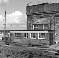 The Association of Community Rail Partnerships has just taken up residence in the ex-LNWR water tower at the north end of Huddersfield station. Back in 1983 it was still in railway use (although not for supplying boiler water of course) and surrounded by the sort of clutter which gave the network so much of its atmosphere.<br>
<br><br>[Bill Jamieson /11/1983]