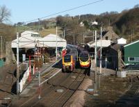 A full house at Oxenholme on 2 February 2013 with (from right to left) in platform 1 a Pendolino for Euston, in platform 2 a double Super Voyager for Glasgow and hiding under the roof in platform 3 is a TPE Class 185 on the Windermere branch service.<br><br>[John McIntyre 02/02/2013]