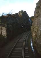 The heavy rock blasting needed to take the railway on from Strome Ferry to Kyle is evident in this view taken from the cab of 26046 on a Kyle-Inverness passenger service on 20th November 1982.<br><br>[Frank Spaven Collection (Courtesy David Spaven) 20/11/1982]