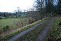 Just east of Rachan Junction the Peebles line passes through a deep (and flooded) cutting before emerging here. View west along the trackbed of the Peebles line towards the junction, with the Talla Railway approaching on the left across a bridge.<br><br>[Ewan Crawford 06/01/2013]