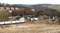 A Virgin Voyager runs south through the site of Grantshouse station with a cross-country service in March 2004 and is about to pass a tamper stabled in the sidings. The photograph shows the scene 40 years after closure of the station to passenger traffic and 43 years after the unwelcome visit of D249 [see image 30150].<br><br>[John Furnevel 16/03/2004]