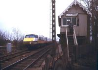 A diverted ECML electric train bound for Kings Cross being dragged through Littleworth station (closed to passengers in 1961) on the GN line between Peterborough and Spalding. View south from the A16 level crossing in January 1991. <br><br>[Ian Dinmore /01/1991]