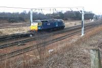 DRS 47237 hurries north on the WCML with a train of flats in March 2004 having just passed through Carstairs station.<br><br>[John Furnevel 17/03/2004]