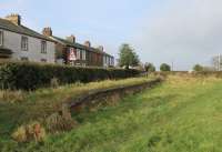 After a short and unprofitable life, famously served by a horse drawn tram for much of its existence, the Port Carlisle branch closed completely in 1932. However, over 80 years later the station platform can still be seen. This view looks towards the buffers but the final stretch of trackbed has been infilled to make a car park for the Port Carlisle Bowling Club, albeit with the platform edging stones still visible. <br><br>[Mark Bartlett 03/02/2013]