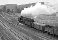 Towards the end of steam, original class 50s had become something of a rarity in East Germany, and one fitted with Wagner smoke deflectors (as opposed to the Witte type familiar in the UK on the A3s) was rarer still. No. 50 1002, shedded at Nossen, therefore had something of a celebrity status, even if the duties on which it was employed were rather modest. Just after 15.30 on a Saturday afternoon in August 1979 it is seen leaving Nossen on a local freight for Riesa.<br><br>[Bill Jamieson 25/08/1979]